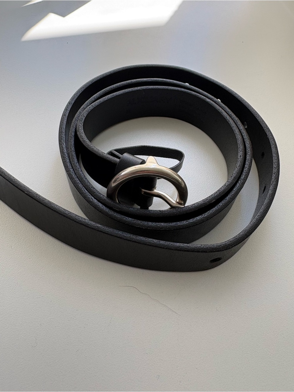 Auxiliary Black Leather Belt with Silver Curved Buckle. Never worn.